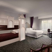 Family-friendly castle bunk room with built-in bunk beds and queen bed, ideal for kids