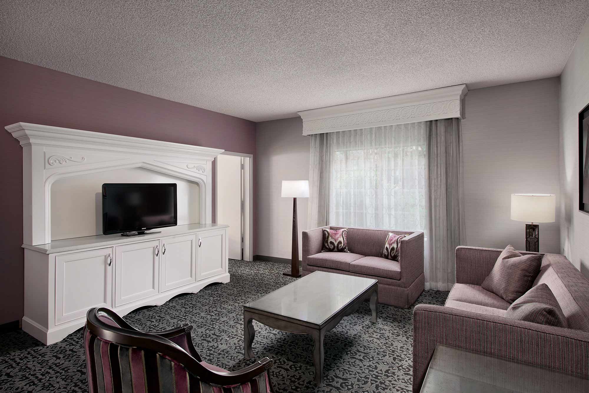 Elegant turret suite with separate living area, sofa seating, and spacious layout at Anaheim Majestic Garden Hotel