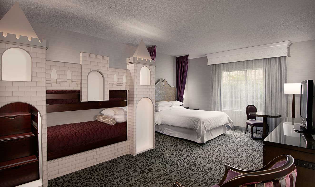Family-friendly castle bunk room with built-in bunk beds and queen bed, ideal for kids
